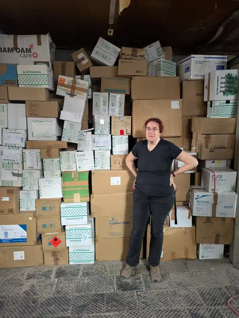 Anna in front of supply boxes in a warehouse